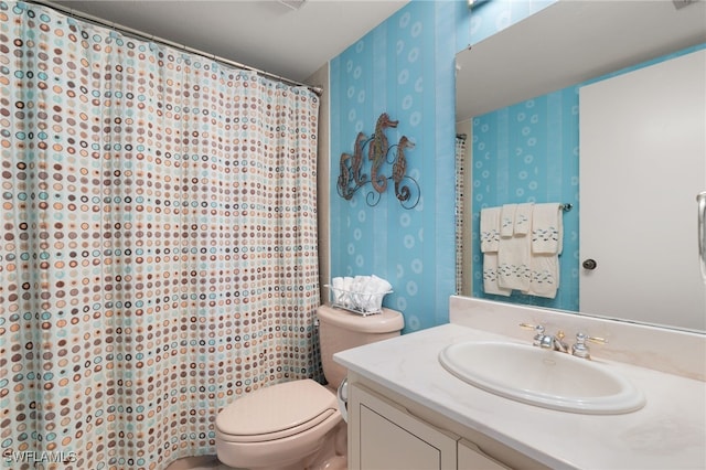 300 S Collier Blvd Unit 2304, Marco Island, FL 34145 - full bathroom featuring wallpapered walls, toilet, vanity, and curtained shower