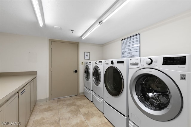 300 S Collier Blvd Unit 2304, Marco Island, FL 34145 - laundry area featuring washing machine and clothes dryer, cabinet space, and baseboards