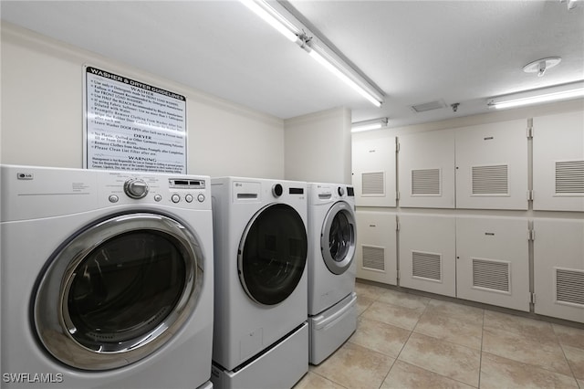 300 S Collier Blvd Unit 2304, Marco Island, FL 34145 - laundry area with washer and dryer and light tile patterned flooring