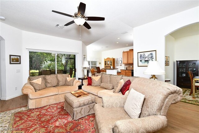 2842 Via Piazza Loop, Fort Myers, FL 33905 - living room with arched walkways, wood finished floors, a ceiling fan, baseboards, and recessed lighting