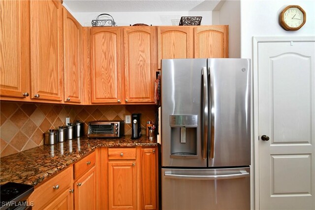 2842 Via Piazza Loop, Fort Myers, FL 33905 - kitchen with appliances with stainless steel finishes, tasteful backsplash, and dark stone countertops