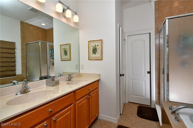 2842 Via Piazza Loop, Fort Myers, FL 33905 - bathroom with tile patterned flooring, a shower stall, and double vanity