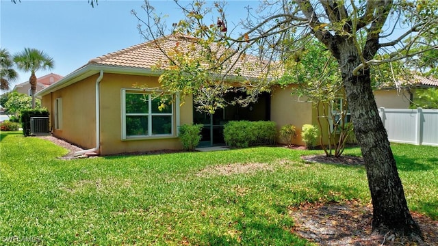2842 Via Piazza Loop, Fort Myers, FL 33905 - back of house featuring stucco siding, central AC unit, and a tiled roof
