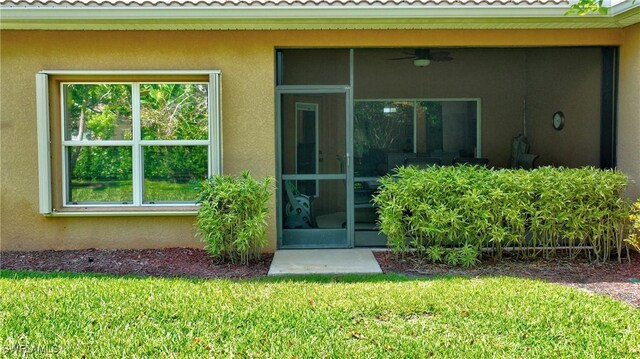 2842 Via Piazza Loop, Fort Myers, FL 33905 - entrance to property with stucco siding, a yard, ceiling fan, and a tile roof