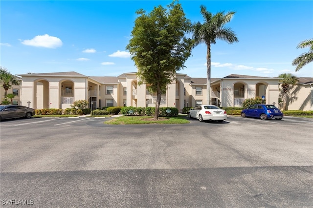 21360 Lancaster Run Unit 1514, Estero, FL 33928 - view of building exterior with uncovered parking and a residential view