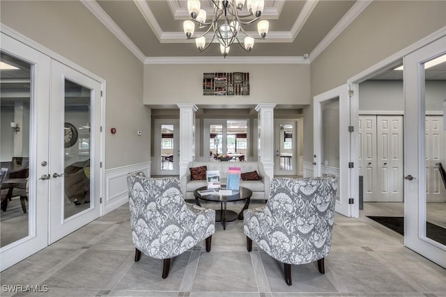 21360 Lancaster Run Unit 1514, Estero, FL 33928 - dining room featuring french doors, decorative columns, a decorative wall, a chandelier, and crown molding