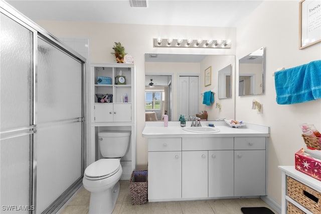 21360 Lancaster Run Unit 1514, Estero, FL 33928 - bathroom featuring vanity, toilet, a shower with door, tile patterned floors, and a ceiling fan