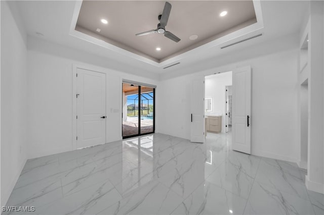 13 NW 14th Ave, Cape Coral, FL 33993 - unfurnished room with a tray ceiling, a ceiling fan, light marble finish flooring, baseboards, and recessed lighting