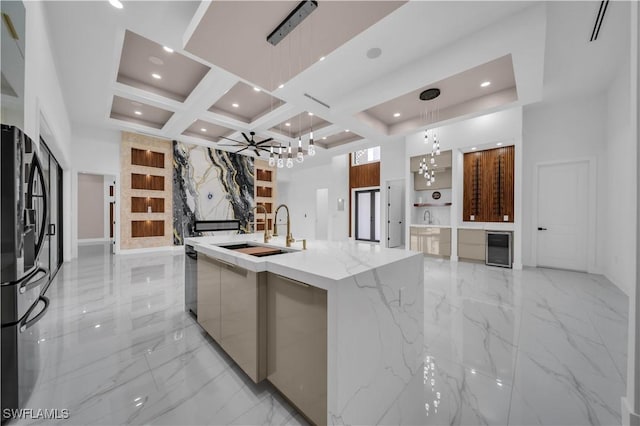 13 NW 14th Ave, Cape Coral, FL 33993 - kitchen with modern cabinets, a sink, a chandelier, light marble finish floors, and freestanding refrigerator