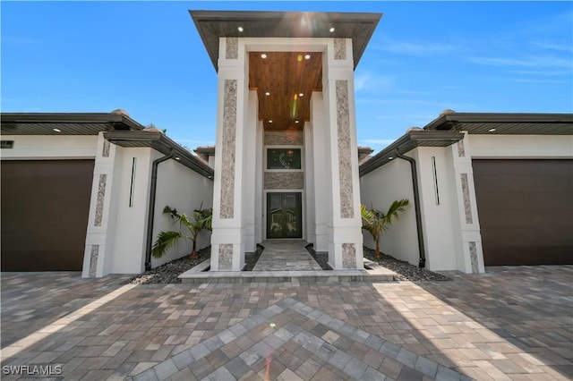 13 NW 14th Ave, Cape Coral, FL 33993 - doorway to property featuring stucco siding and a garage