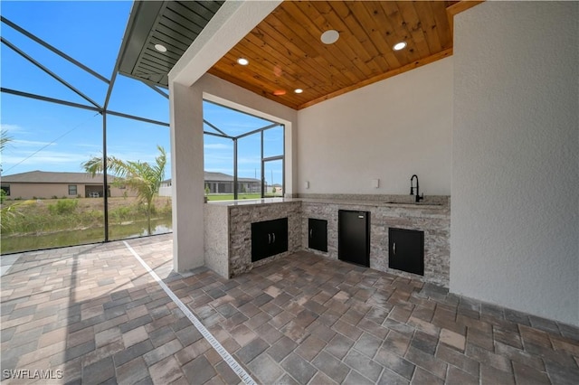 13 NW 14th Ave, Cape Coral, FL 33993 - view of patio / terrace featuring a sink, an outdoor kitchen, and a lanai