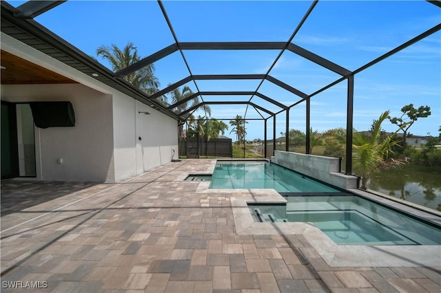 13 NW 14th Ave, Cape Coral, FL 33993 - view of swimming pool with a patio area, glass enclosure, a water view, and a pool with connected hot tub