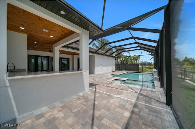 13 NW 14th Ave, Cape Coral, FL 33993 - view of pool featuring a patio, glass enclosure, and a pool with connected hot tub