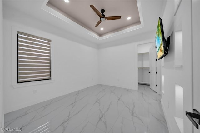 13 NW 14th Ave, Cape Coral, FL 33993 - unfurnished room featuring baseboards, a raised ceiling, a ceiling fan, recessed lighting, and marble look tile flooring