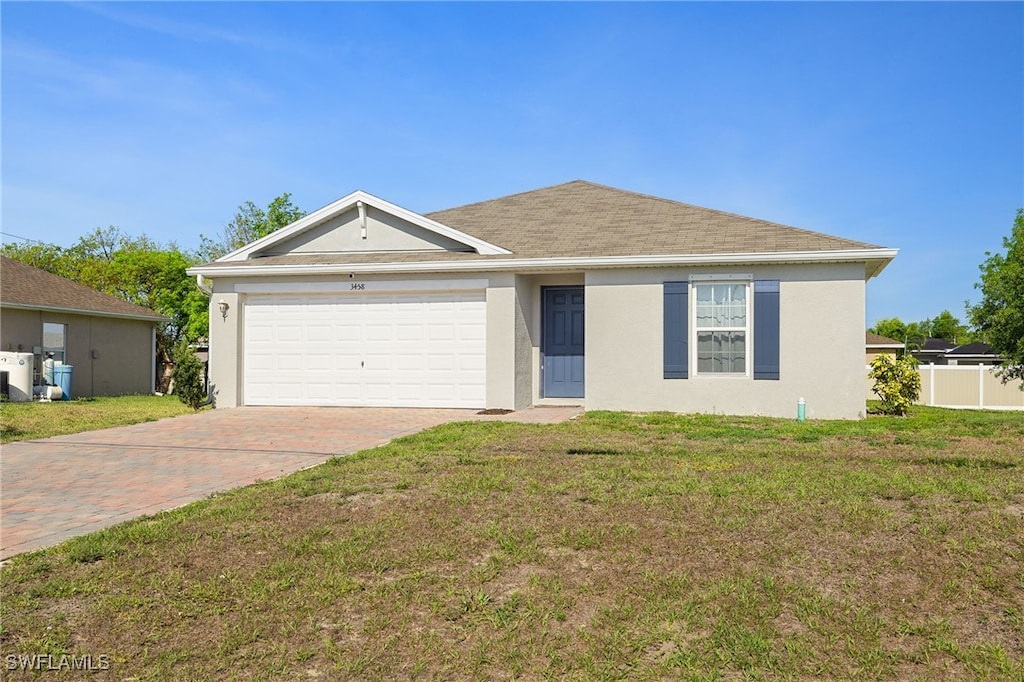 3458 NE 10th Ave, Cape Coral, FL 33909 - ranch-style house with stucco siding, decorative driveway, and a garage