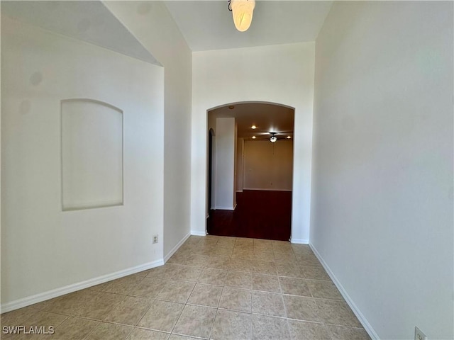 12635 Stone Tower Loop, Fort Myers, FL 33913 - hallway featuring arched walkways, light tile patterned floors, and baseboards