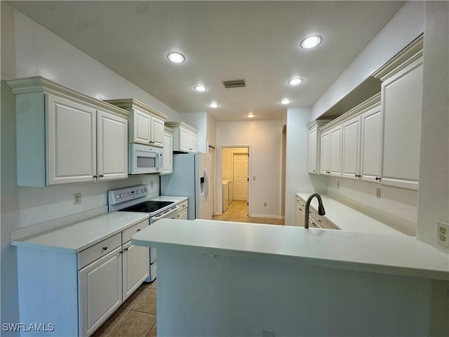 12635 Stone Tower Loop, Fort Myers, FL 33913 - kitchen with white appliances, light tile patterned floors, a sink, recessed lighting, and washer and clothes dryer