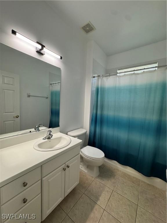 12635 Stone Tower Loop, Fort Myers, FL 33913 - bathroom featuring tile patterned floors, toilet, vanity, and curtained shower