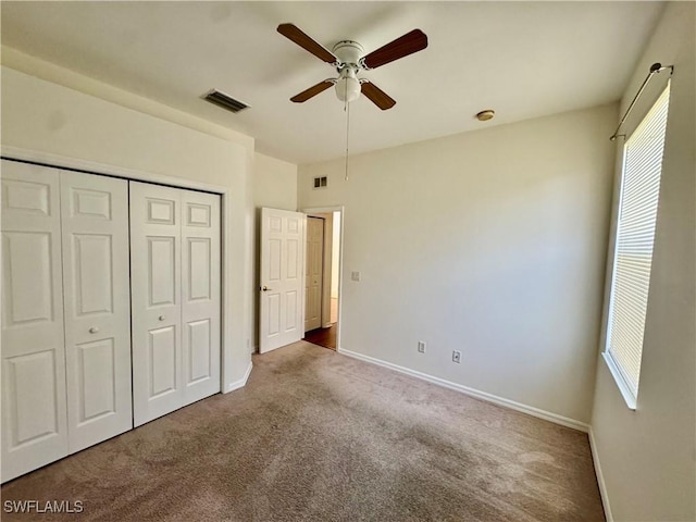 12635 Stone Tower Loop, Fort Myers, FL 33913 - unfurnished bedroom featuring carpet, multiple windows, baseboards, and a closet
