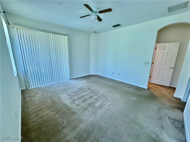 12635 Stone Tower Loop, Fort Myers, FL 33913 - carpeted spare room featuring ceiling fan, baseboards, and arched walkways