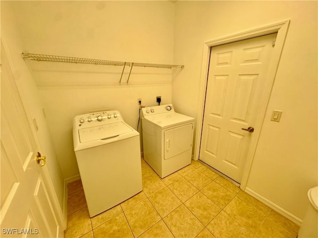 12635 Stone Tower Loop, Fort Myers, FL 33913 - laundry area featuring independent washer and dryer, light tile patterned floors, and baseboards