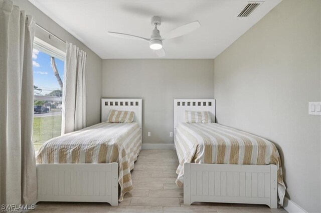 5748 Linden Ln, Bokeelia, FL 33922 - bedroom featuring wood finished floors, baseboards, and ceiling fan