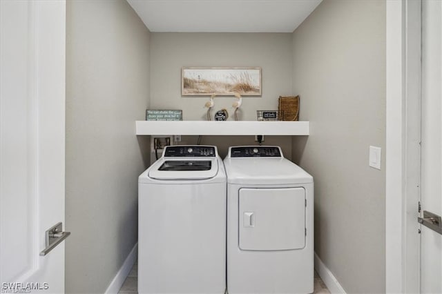 5748 Linden Ln, Bokeelia, FL 33922 - laundry room featuring separate washer and dryer and baseboards
