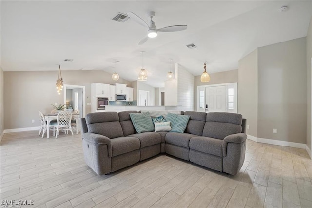 5748 Linden Ln, Bokeelia, FL 33922 - living area with light wood-style flooring, baseboards, lofted ceiling, and ceiling fan