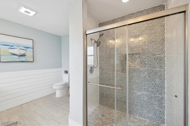 5748 Linden Ln, Bokeelia, FL 33922 - full bath featuring toilet, a wainscoted wall, and a shower stall