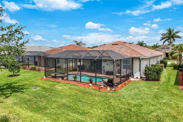 3147 Walnut Grove Ln, Alva, FL 33920 - rear view of property with a lawn, a tiled roof, a pool with connected hot tub, a patio, and a lanai