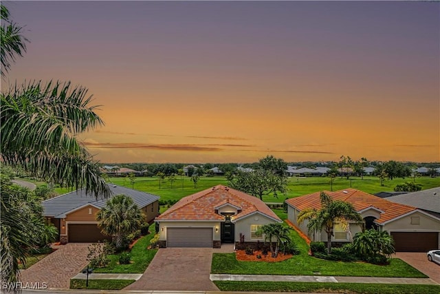 3147 Walnut Grove Ln, Alva, FL 33920 - mediterranean / spanish-style house with a front lawn, driveway, a tiled roof, and an attached garage