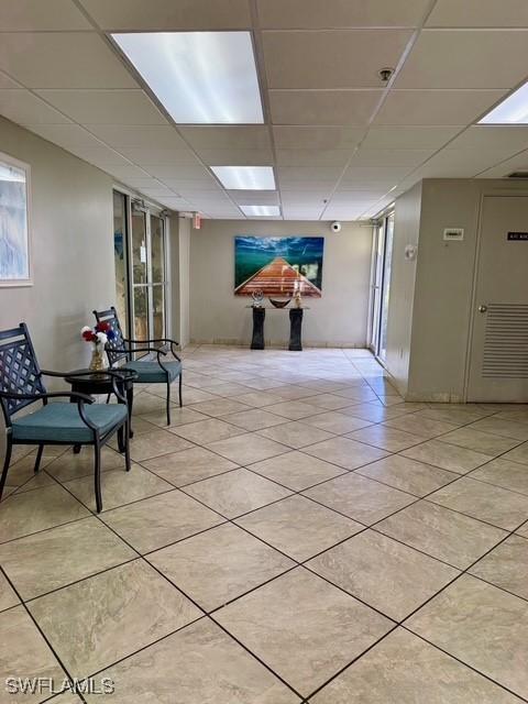 3910 Inverrary Blvd Unit 407-B, Lauderhill, FL 33319 - hallway with a drop ceiling and light tile patterned flooring