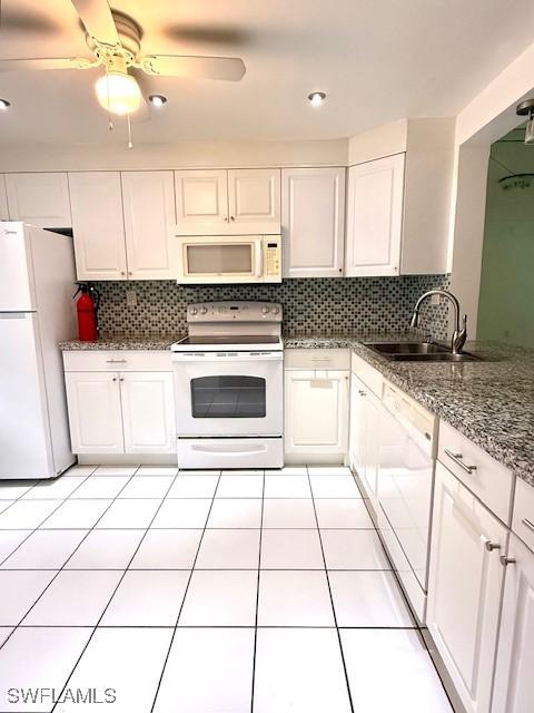 3910 Inverrary Blvd Unit 407-B, Lauderhill, FL 33319 - kitchen featuring white appliances, a sink, white cabinets, and backsplash