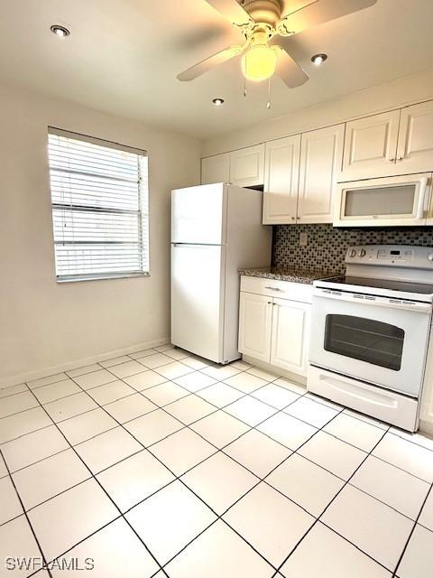 3910 Inverrary Blvd Unit 407-B, Lauderhill, FL 33319 - kitchen with white appliances, backsplash, white cabinets, dark countertops, and light tile patterned floors
