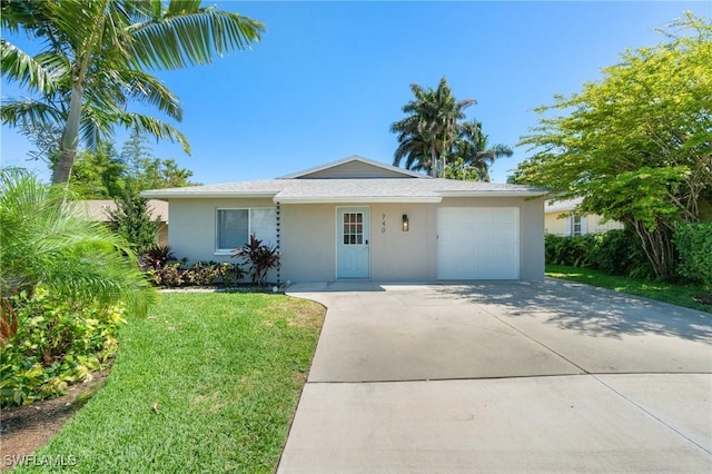 740 106th Ave N, Naples, FL 34108 - single story home featuring a garage, stucco siding, concrete driveway, and a front yard