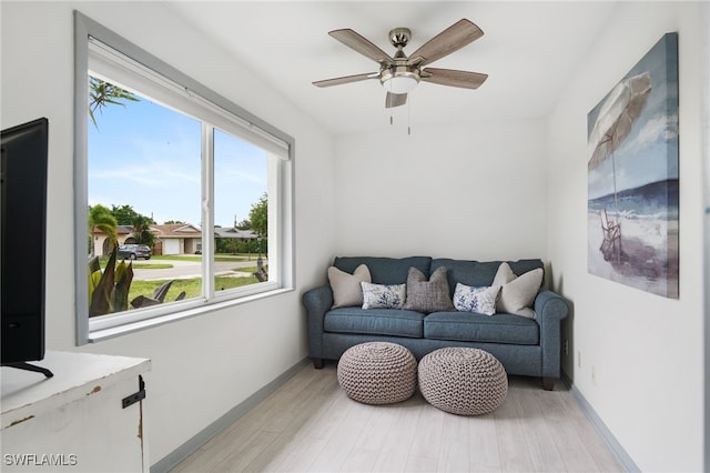 740 106th Ave N, Naples, FL 34108 - living room featuring healthy amount of natural light, light wood-style floors, ceiling fan, and baseboards