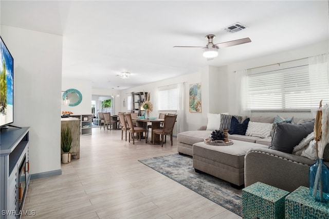 740 106th Ave N, Naples, FL 34108 - living room featuring a ceiling fan and light wood-style floors