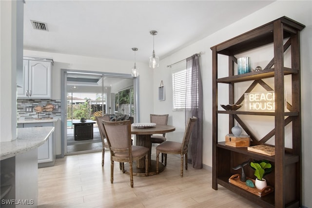 740 106th Ave N, Naples, FL 34108 - dining space with healthy amount of natural light and light wood-style floors
