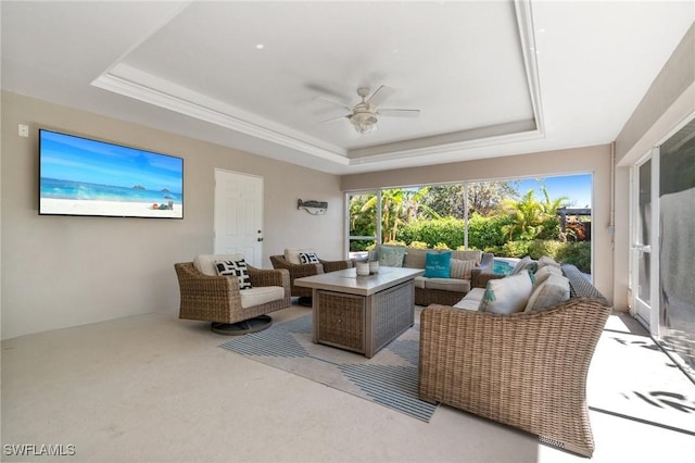 740 106th Ave N, Naples, FL 34108 - living room featuring a tray ceiling, a ceiling fan, and light colored carpet