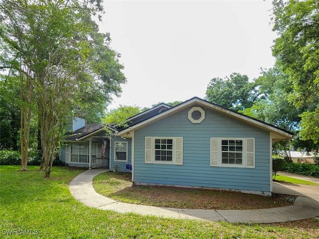 bungalow-style home featuring a front lawn and a chimney