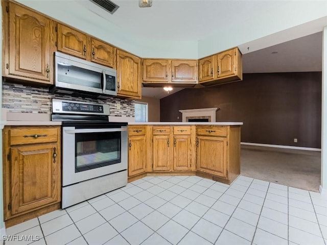 kitchen with stainless steel appliances, light carpet, light countertops, and tasteful backsplash