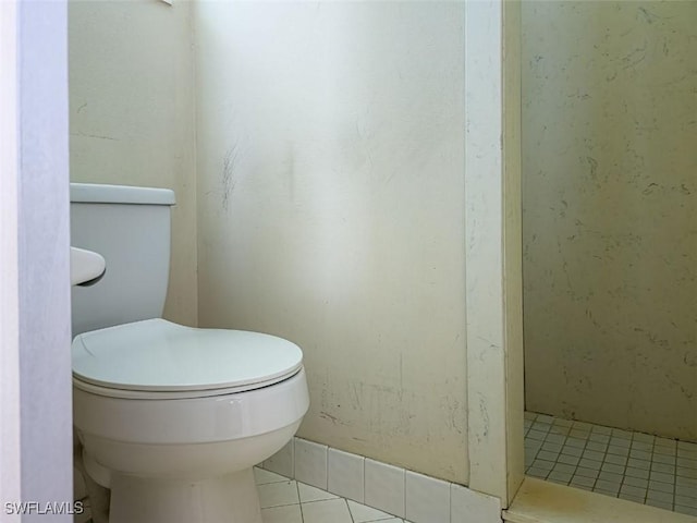 full bath featuring tile patterned flooring, toilet, and a stall shower