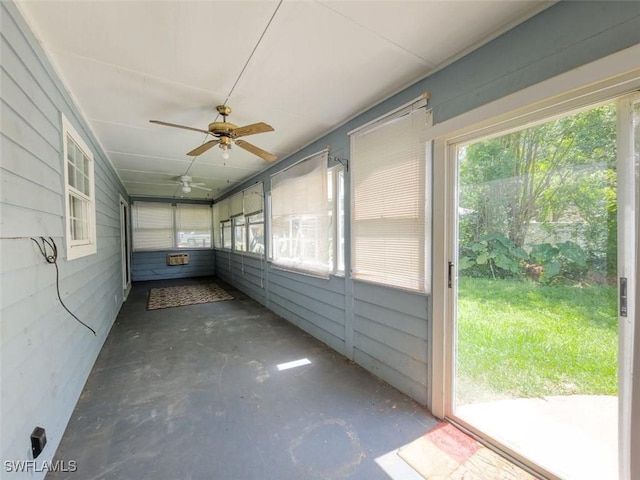 unfurnished sunroom featuring ceiling fan
