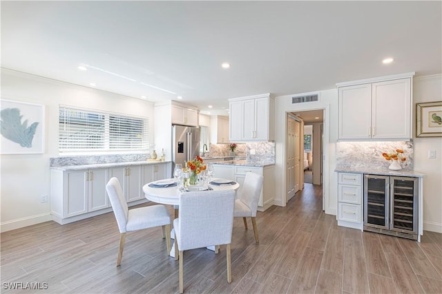 2100 Gulf Shore Blvd N Unit 118, Naples, FL 34102 - dining room featuring wine cooler, light wood-style floors, baseboards, and recessed lighting