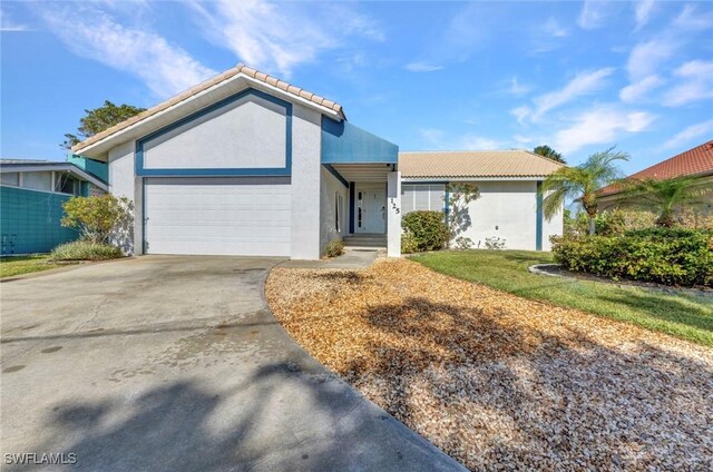125 Donna Ct, Punta Gorda, FL 33950 - single story home featuring stucco siding, a garage, a tiled roof, and driveway