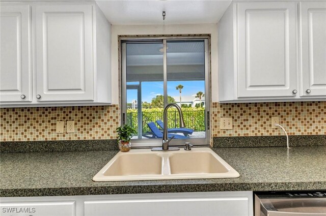125 Donna Ct, Punta Gorda, FL 33950 - kitchen featuring a sink, dishwasher, white cabinetry, dark countertops, and tasteful backsplash