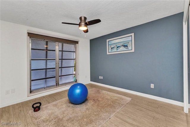 125 Donna Ct, Punta Gorda, FL 33950 - workout room featuring baseboards, ceiling fan, and wood finished floors