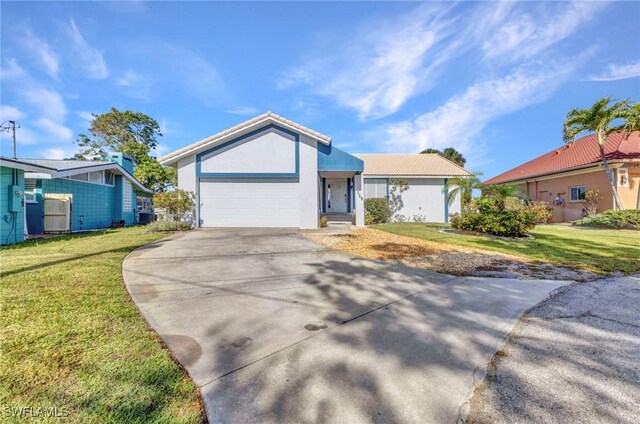 125 Donna Ct, Punta Gorda, FL 33950 - single story home featuring concrete driveway, a front yard, an attached garage, and stucco siding