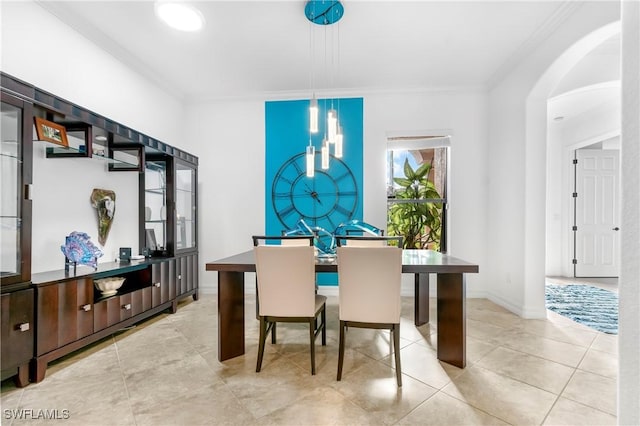 10986 Longwing Dr, Fort Myers, FL 33912 - dining space featuring ornamental molding, arched walkways, tile patterned flooring, and baseboards