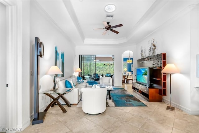 10986 Longwing Dr, Fort Myers, FL 33912 - living area featuring ceiling fan, a raised ceiling, baseboards, ornamental molding, and arched walkways